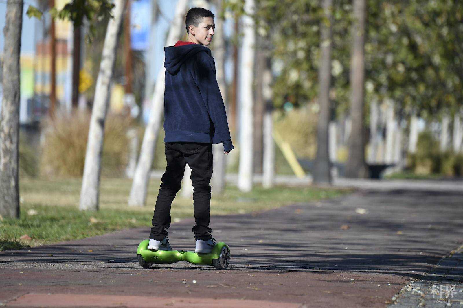 A boy rides a hoverboard on the day after Christmas, in San Pedro, California December 26, 2015. Reports of some hoverboards, also known as self-balancing, two-wheeled scooters catching fire have led to an investigation by the Consumer Product Safety Commission.AFP PHOTO / ROBYN BECK / AFP / ROBYN BECK(Photo credit should read ROBYN BECK/AFP via Getty Images)